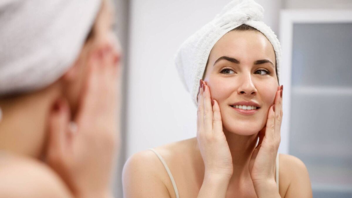 Woman looking herself in mirror
